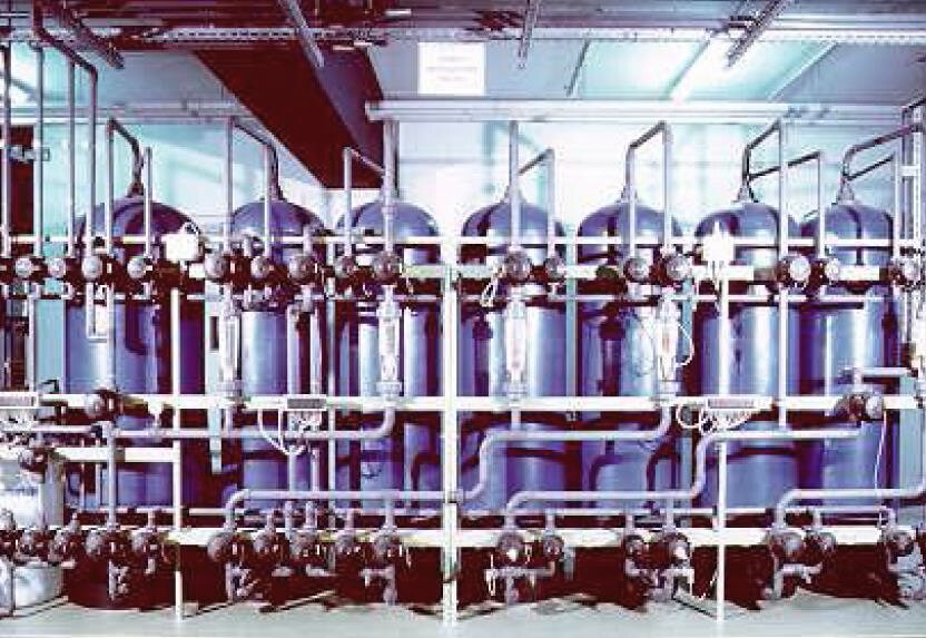 Row of ion-exchange columns with valves and piping
