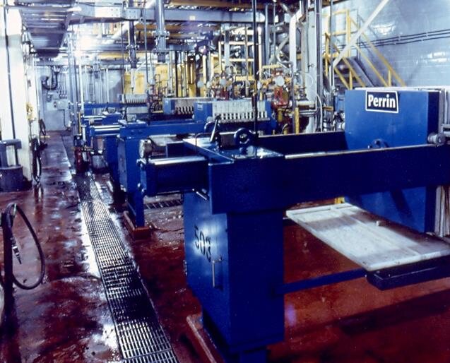 Row of filter presses on the refinery floor